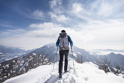 Hiker walking on mountain peak snowy