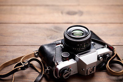 Vintage camera on old wooden table