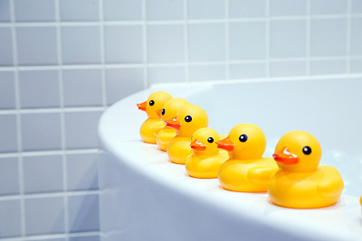 Small yellow duck on the bathtub