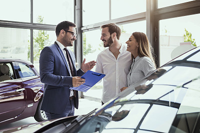 Young couple buying a car