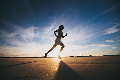 Male runner out for a training run at sunset