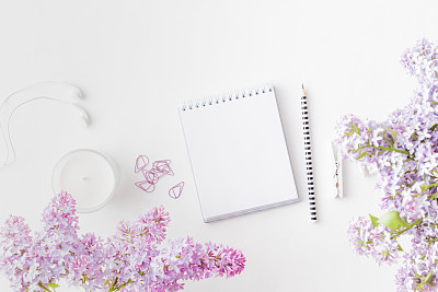Mockup white notebook with  branches of lilac on a light background