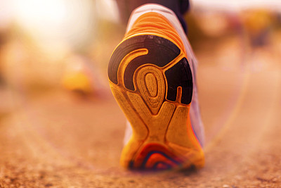 Runner Man Feet Running on Road closeup on shoe