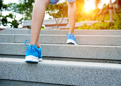 Young man climbing up stairs