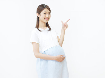 smiling Asian woman check mark gesture