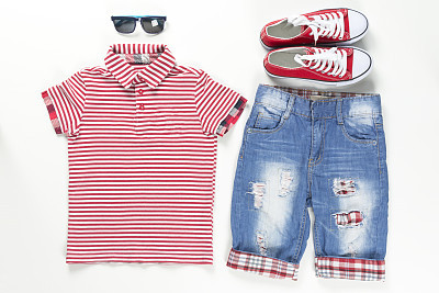 Collage set of children clothes. Blue and red color wear on a white Concept spring and summer clothes. Close-up.