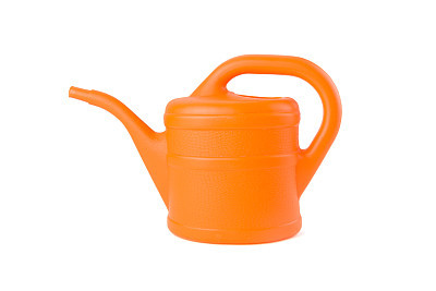 orange watering can on white background