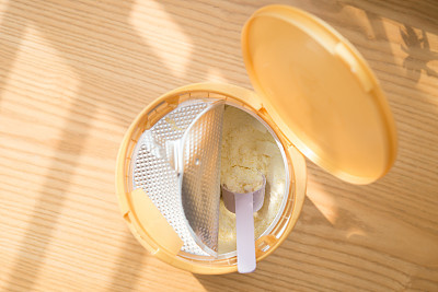 can of powdered milk for children on wooden table