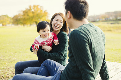 Happy family having a good time with baby girl