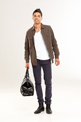 Stylish young man with a leather bag over white