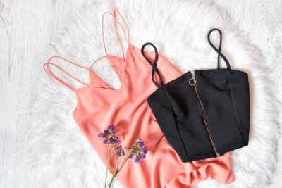 Black and pink top, wildflowers on a white fur. Fashionable concept