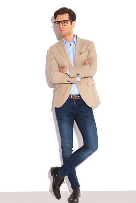 man wearing glasses posing in white studio