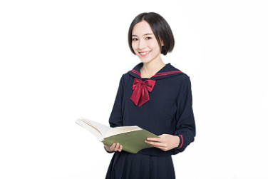 female student reading textbook