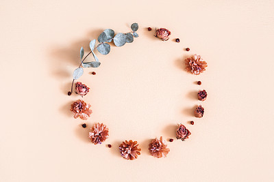 Autumn composition. Wreath made of dried flowers, eucalyptus leaves, berries on beige background. Autumn, fall, thanksgiving day concept. Flat lay, top view, copy space