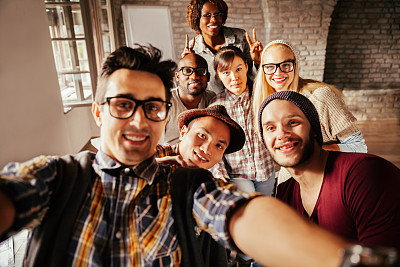 Coworkers taking a photo of themselves