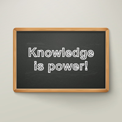knowledge is power on blackboard in wooden frame