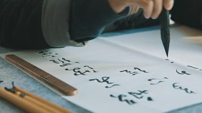 Man writing calligraphy