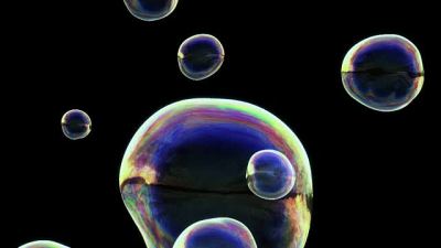 Soap bubbles falling downwards