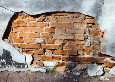 brick wall with destroyed plaster
