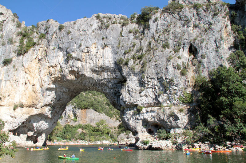 Canoes on Ardèche River in front of Pont d’Arc