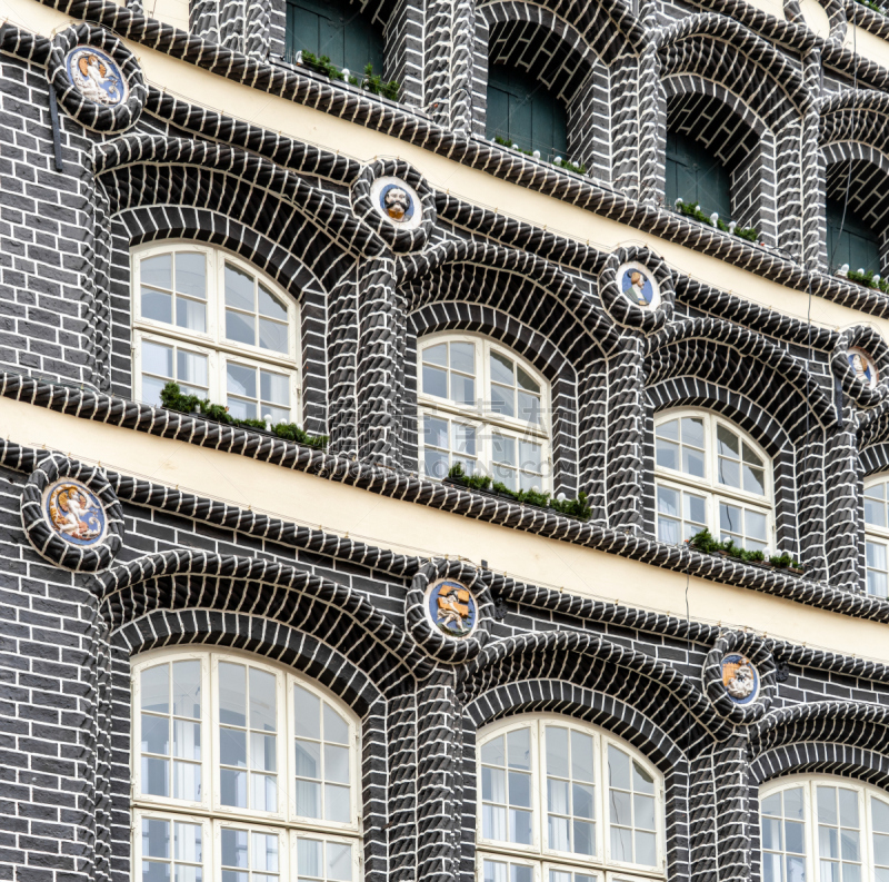 Historical building with black bricks and decorations on the faÃ§ade