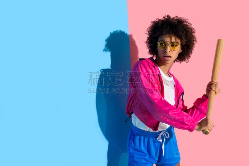 Young bright african american girl with baseball bat