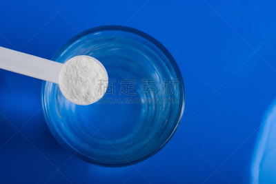 Sport supplement, creatine, hmb, bcaa, amino acid or vitamin - mesure with powder over a glass of water. Sport nutrition concept.
