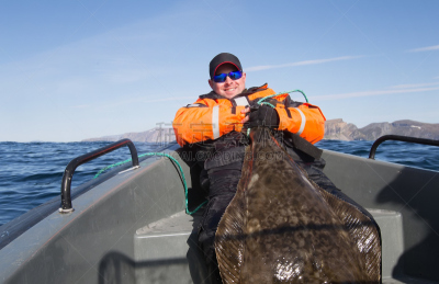 Fisherman holding the tail of a huge fish. horizontal frame