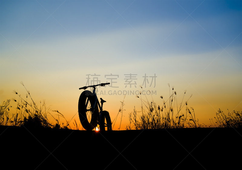 beautiful sunset sky and mountain bike silhouette , silhouette fat bike