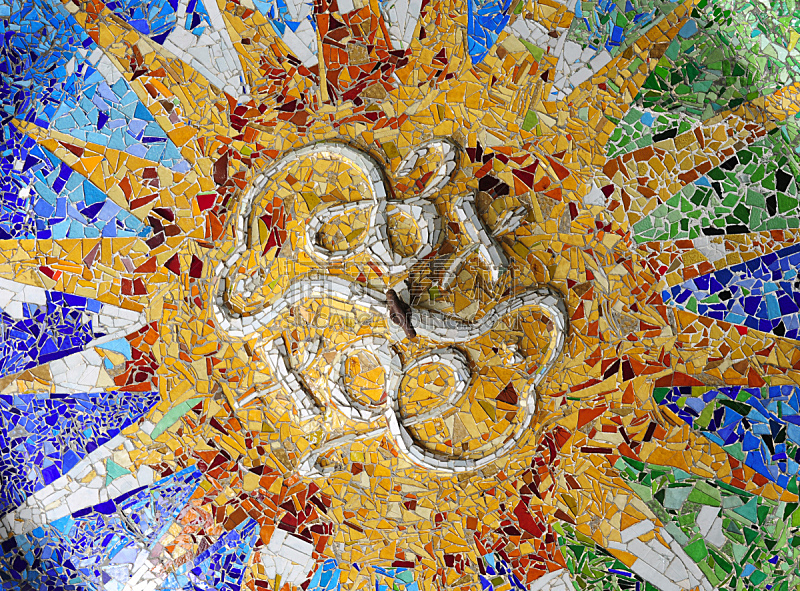 Colored tile mosaic on the ceiling of the Hypostyle Hall, Park Guell.Park Guell was designed by the Catalan architect Antoni Gaudí and built in the years 1900 to 1914. It is part of the UNESCO World Heritage Site "Works of Antoni Gaudí".