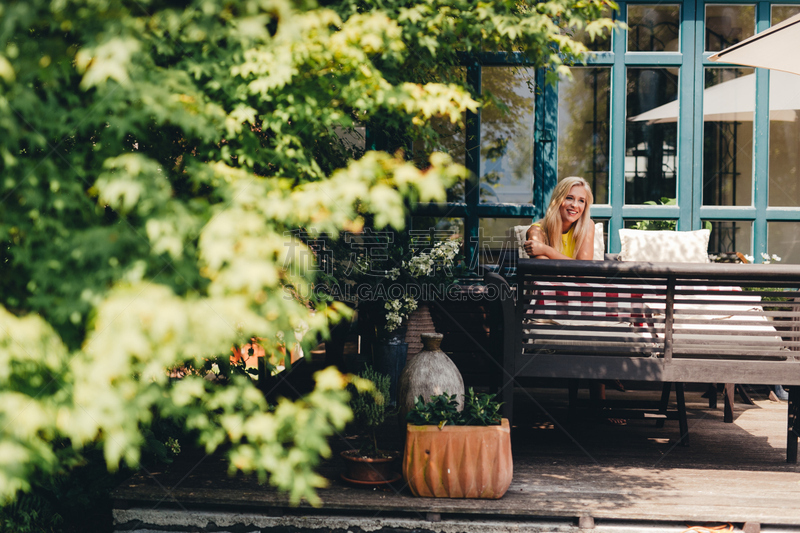 Beautiful young woman sitting in vintage ambient.