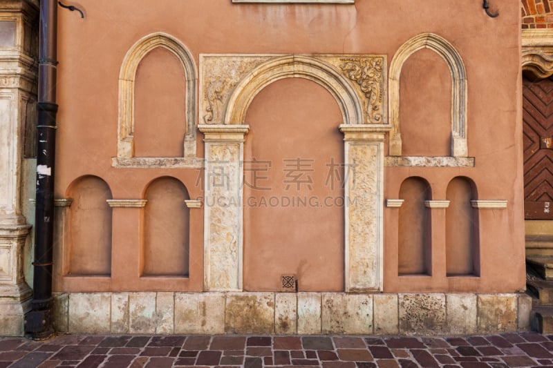 Arched niches od different size on St Barbara’s Church wall in Old Town of Krakow in Poland.