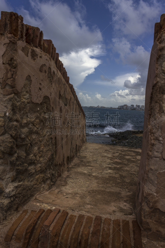 Peaks of Puerto Rico´s beaches in San juan overviewed by the Masonry Walls. These sneak peaks of the beaches show why tourists visit this place during vacations to take pictures like these; with clear blue skies, calm blue waters and old mantained archite