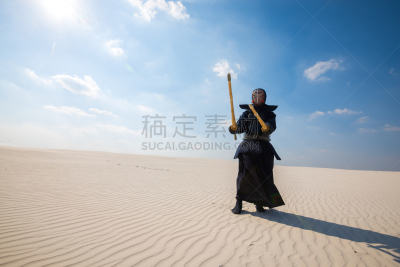 Man, in a traditional japanese armor is practicing kendo