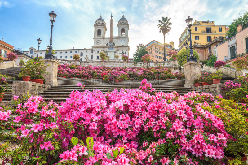 Spanish Steps in the morning with azaleas in Rome, Italy. Rome Spanish Steps (Scalinata della Trinità dei Monti) are a famous landmark and attraction of Rome and Italy.