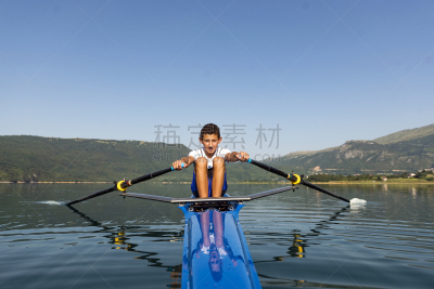 The young sportsman is rowing on the racing kayak