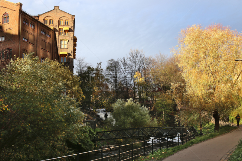 Walking path along the river in city in autumn.  Waterfall at Mølla.