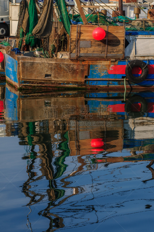 Fisherman boats moored along channel