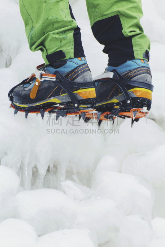 Ice climbing the North Caucasus, man climbing frozen waterfall.