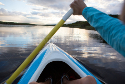 POV of a woman holding a paddle as she paddles