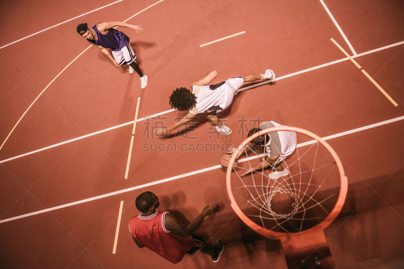 Guys playing basketball