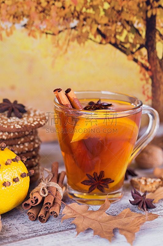 Autumn hot tea with lemon in glass cup.