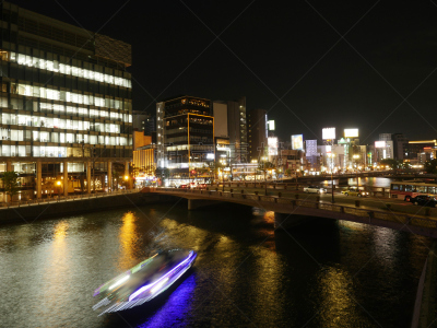 Night view of ‘Nakasu’ and illuminated cruise ship. Fukuoka city, urban district.