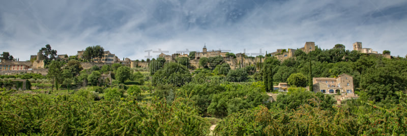 View of Ménerbes in early summer with cherry trees, Provence, Luberon, Vaucluse, France