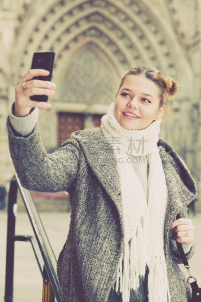 girl taking picture selfie in scarf