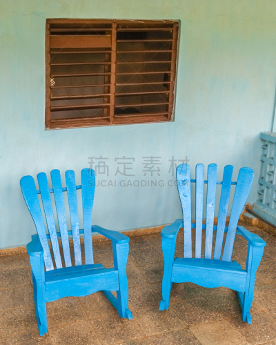 Two blue rocking chairs on a porch in Viñales, Cuba.