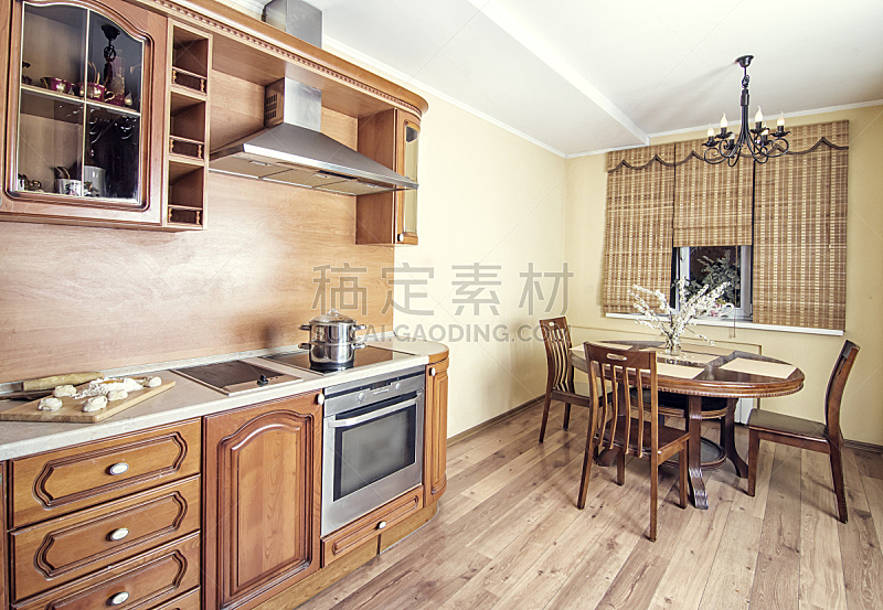 cooking on luxury kitchen with oven and wooden table