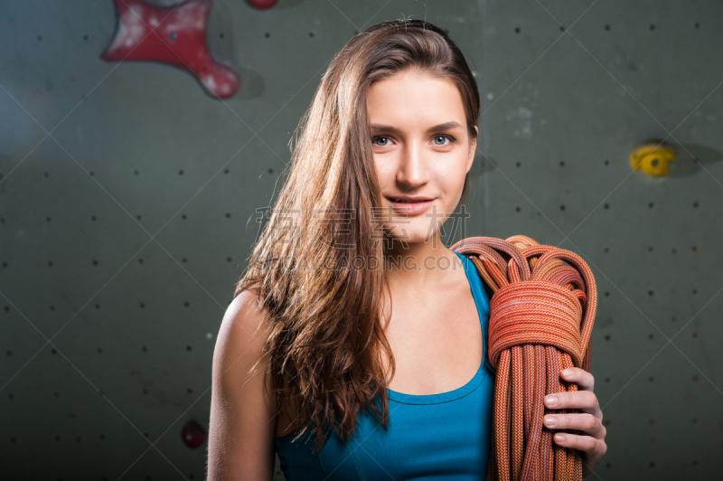 Fit woman with climbing equipment