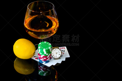 Сards with chips to play poker and snifter brandy with lemon