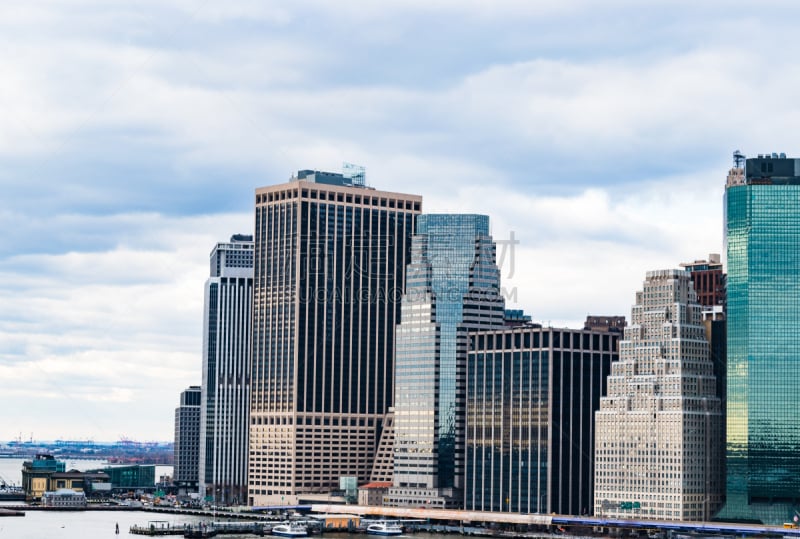 Cityscape of New York’s downtown/ financial district showing the commuter piers on a cloudy afternoon